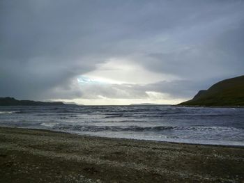 Scenic view of sea against cloudy sky