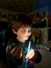 Portrait of boy holding indoors