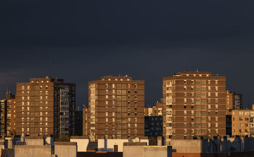 Residential buildings of madrid, spain, during sunset, against blue sky