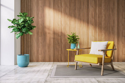 Potted plant on table against wall at home