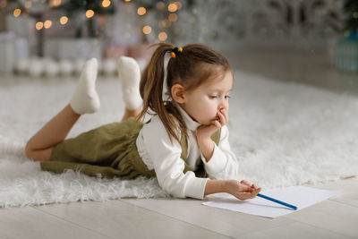 Portrait of young woman using digital tablet at home