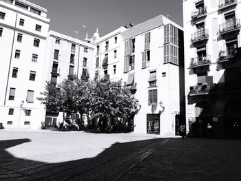 Street amidst buildings in city against sky