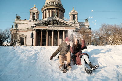 Couple in snow against saint isaac cathedral 