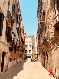 Narrow street amidst buildings in city