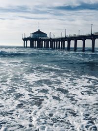 Pier over sea against sky