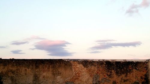 Low angle view of wall against sky