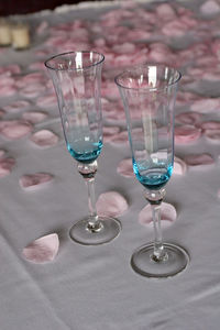 Close-up of glasses with petals on table