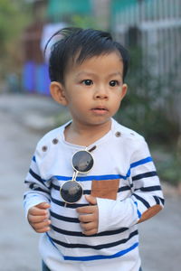 Asian boys wearing black fashion glasses and white striped shirts.