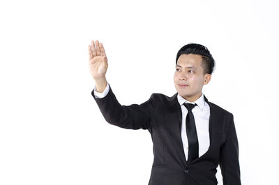 Young man standing against white background