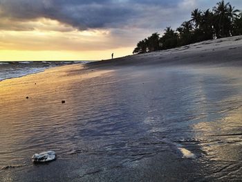 Scenic view of sea against cloudy sky