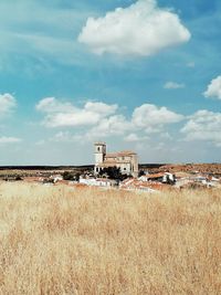 Abandoned building on field against sky