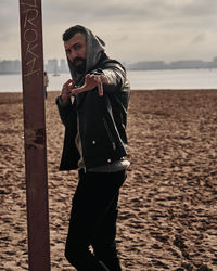 Full length of young man standing on beach