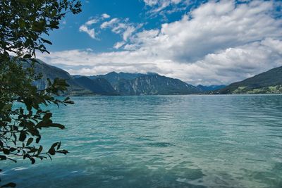 Scenic view of sea and mountains against sky