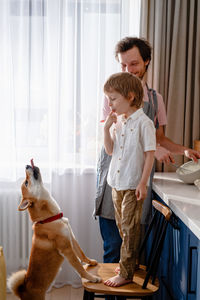 Full length of a boy standing with dog