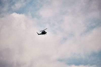 Low angle view of silhouette airplane against sky