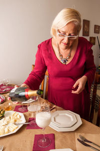 Midsection of man standing by food on table