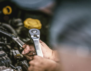 Close-up of mechanic repairing car