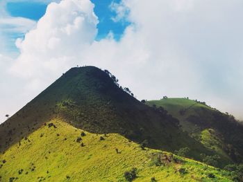Scenic view of mountains against cloudy sky