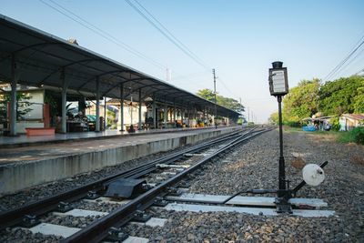 Railroad station platform against clear sky