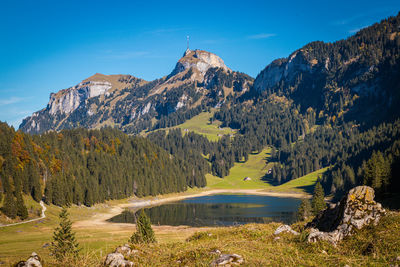 Scenic view of mountains against blue sky