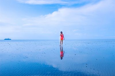 Rear view of person standing on beach