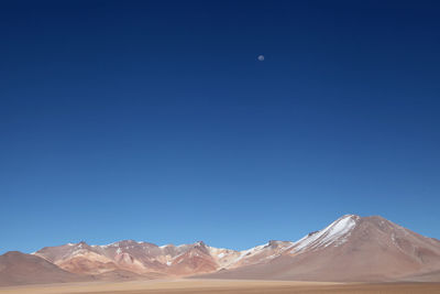 Scenic view of mountains against cloudy sky