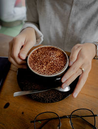 Midsection of woman holding coffee