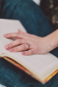 Midsection of woman reading book