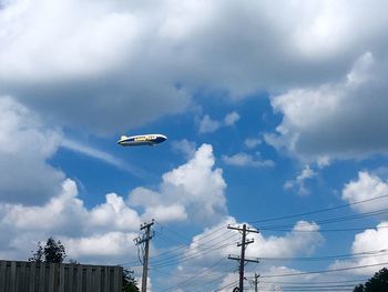 Low angle view of bird flying against sky