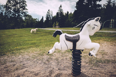 Horse sculpture on grassy field