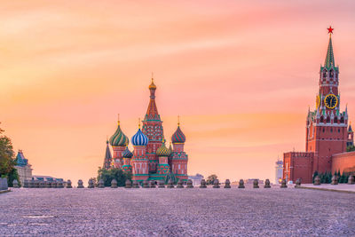 View of buildings in city against sky during sunset