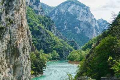 Scenic view of river amidst mountains