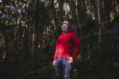 Woman standing in forest