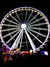 Low angle view of ferris wheel at night