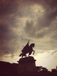 Low angle view of statue against cloudy sky