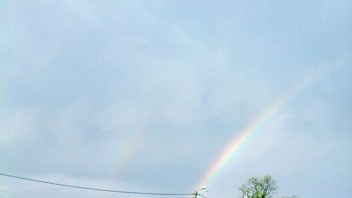 Low angle view of rainbow against sky