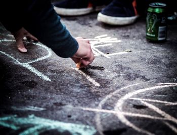 Close-up of person drawing on road