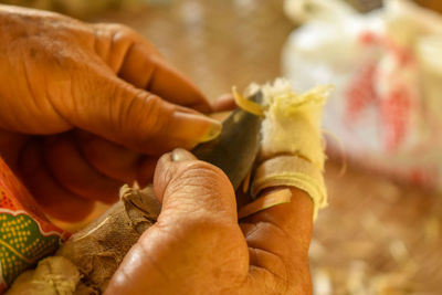 Cropped hands of craftsperson holding knife at workshop