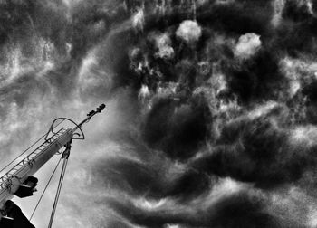 Low angle view of communications tower against sky