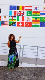 Portrait of woman standing against multi colored wall