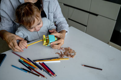 Midsection of man working on table