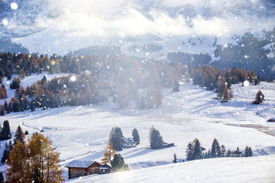 High angle view cottages on snow covered mountain