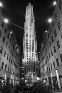 Low angle view of illuminated buildings against sky at night