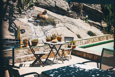 Chairs and tables on table against mountain