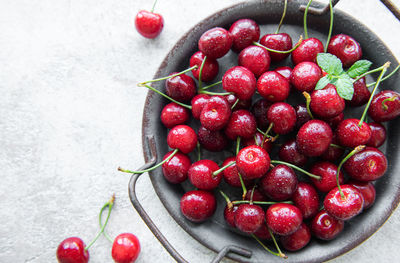 Fresh red cherries fruit on a concrete background