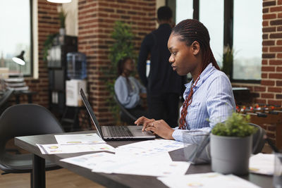 Young man using laptop at office