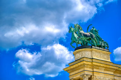 Low angle view of statue against cloudy sky