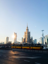 Buildings in city against clear blue sky