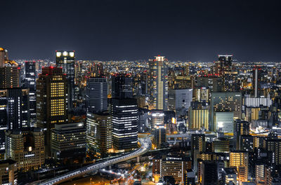 High angle view of illuminated city buildings against sky