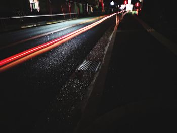Light trails on road in city at night